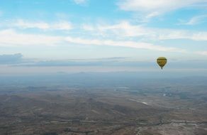 balloon over scenic cappadocia