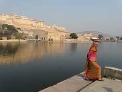 girl in national dress by the river in Jaipur, India