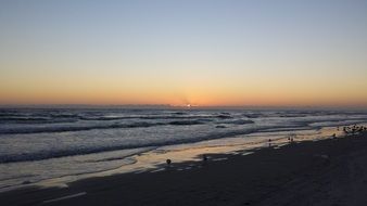 distant view of the rays of dawn on the horizon over the ocean