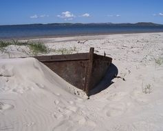 abandoned rusty Boat in Sand on Beach