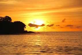 golden sunset over quiet water