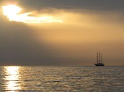 Landscape of sailing ship at the sunset