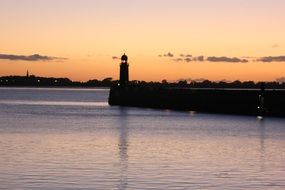 silhouettes of lighthouse at sunset in bremerhaven