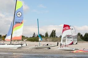 Colorful sailboats on the sandy beach of the sea