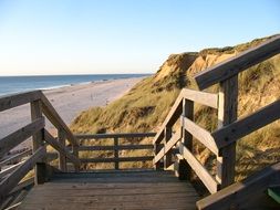 wooden stairway at Red Cliff, rusty-red glacial till on Beach of North Sea, germany, Sylt