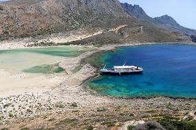 panoramic landscape view of a ship in a bay in crete