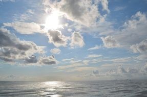 landscape of white clouds reflected in the north sea in cuxhaven