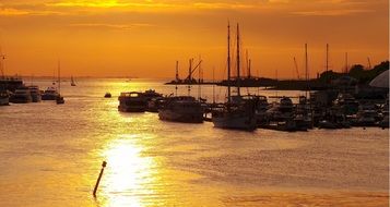 boats on the water in the port at sunset