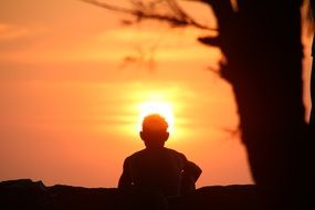 silhouette of a man in the rays of the setting sun