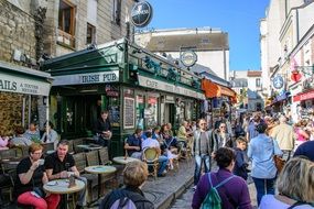 many tourists in a cafe in montmartre