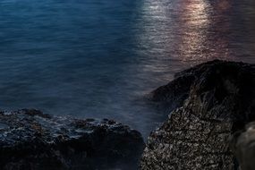Landscape of the rocky beach at the sunset