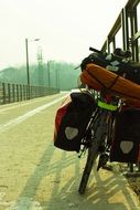 heavy loaded Bike parked at fence on roadside