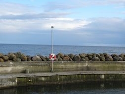 life buoy on a fence near a lake
