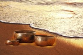 picture of the Singing Bowls on a beach