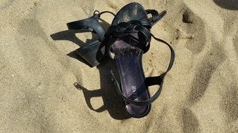 black female Shoes on Sand Beach