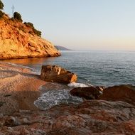 stones on the sea coast at sunset