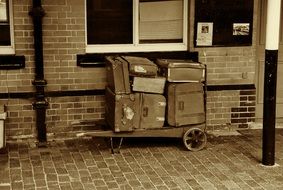 retro luggage near the building in monochrome image