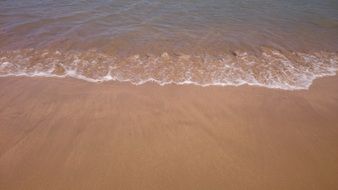 Quiet water on the sandy shore