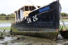 abandoned wooden boat on the shore