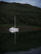 distant view of a white yacht in calm twilight