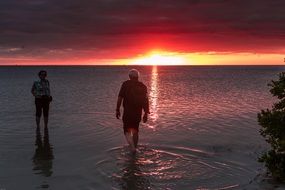 two at sea at a romantic sunset