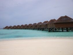 row of water bungalows in maldives