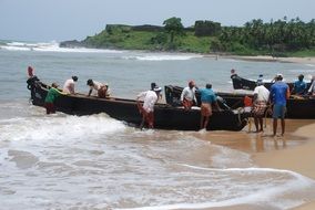 Picture of Fishermen are on a beach in Kerala