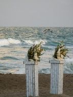 wedding columns with flowers on the beach