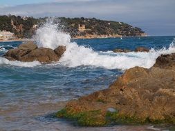 tide of the waves on the stones in the sea