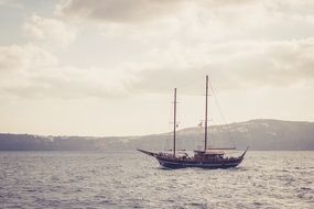 sailing boat at sea on the background of the Greek island
