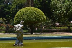 sculpture of St. Lawrence in a green park