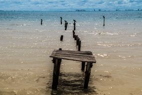 ruined wooden pier in the water