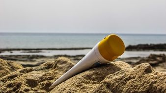 sun cream lies on the sand