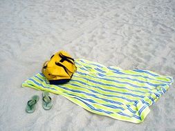 Flip Flops and towel on a beach