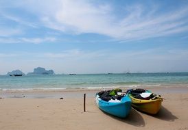 two boats on the coast of thailand on a sunny day