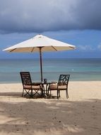 landscape of table with chairs on the beach in Mauritius