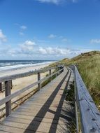 long Boardwalk with railing on Sea Coast
