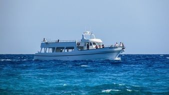cruise ship with tourists in the blue sea