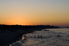 Sunset above dark coast of Baltic Sea