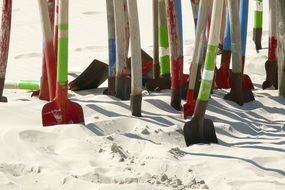 lot of colorful shovels in Sand on Beach