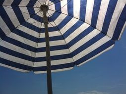 striped beach umbrella under the sun