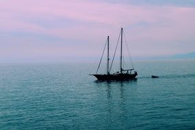 sailing boat in a calm sea on the coast of Italy