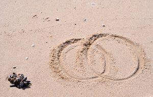 Rings on sandy beach with the stones