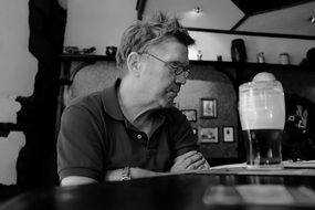 black and white photo deep thinker in a pub