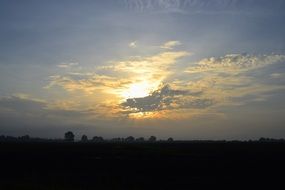 yellow sunset in gray clouds