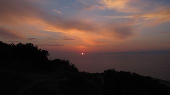 sunset over the mediterranean coast of greece