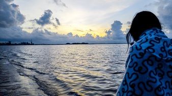 girl on the beach waiting for sunrise