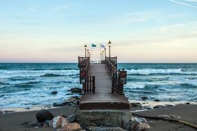 Bridge on the edge of the sea with the sand