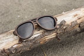 Beautiful brown sunglasses on the wood