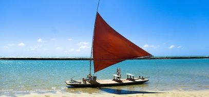 red canvas Boat on a sea bank